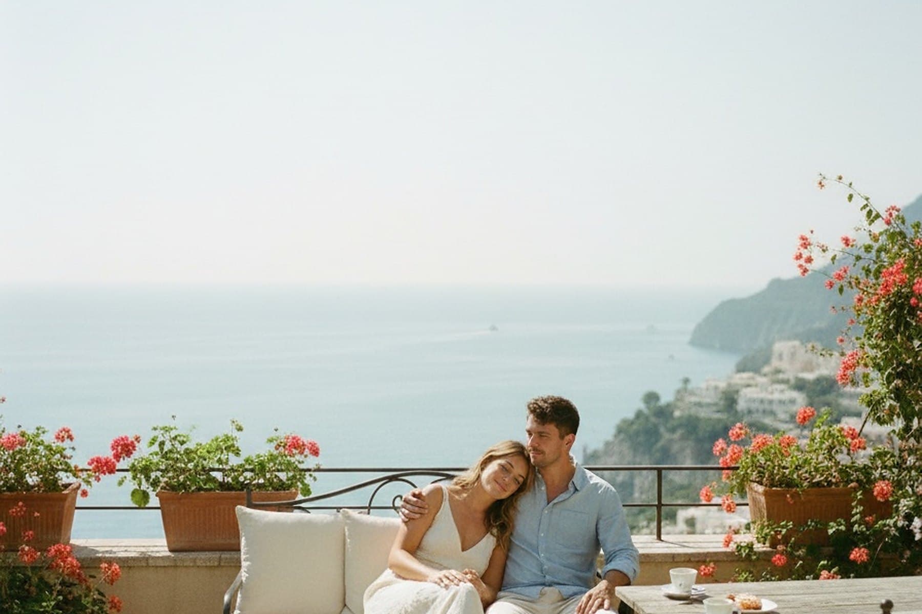 A couple on a seaside terrace at dusk